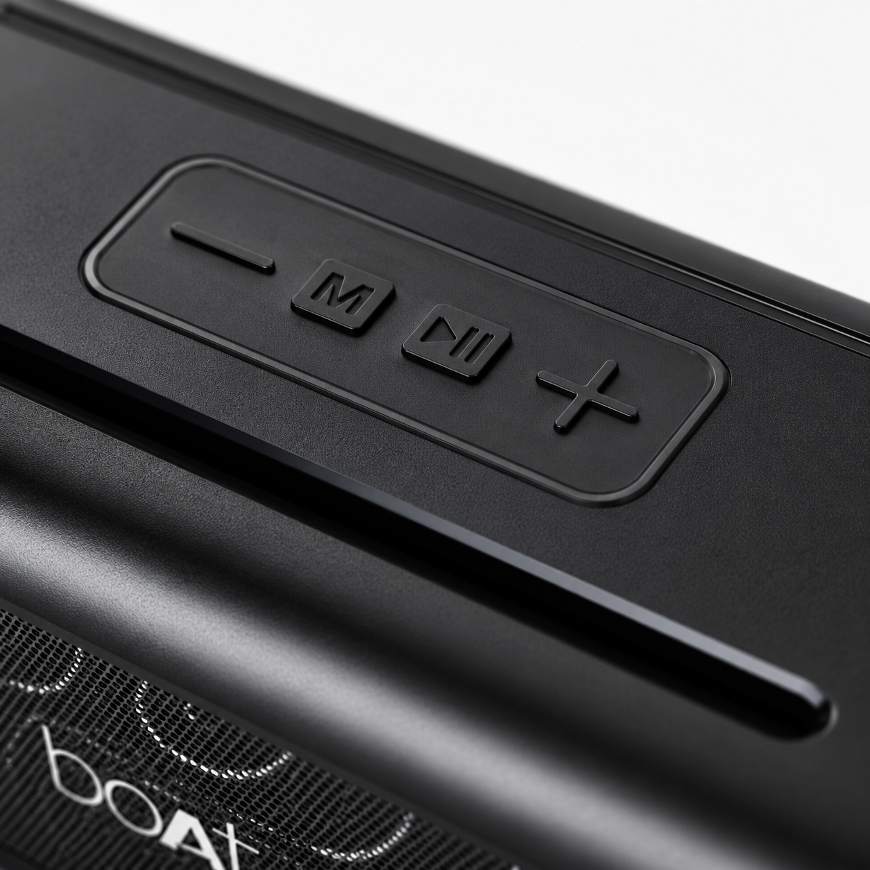 Premium close-up of the textured top panel featuring tactile volume, mode, play/pause, and volume control buttons on a rugged portable wireless Bluetooth speaker.