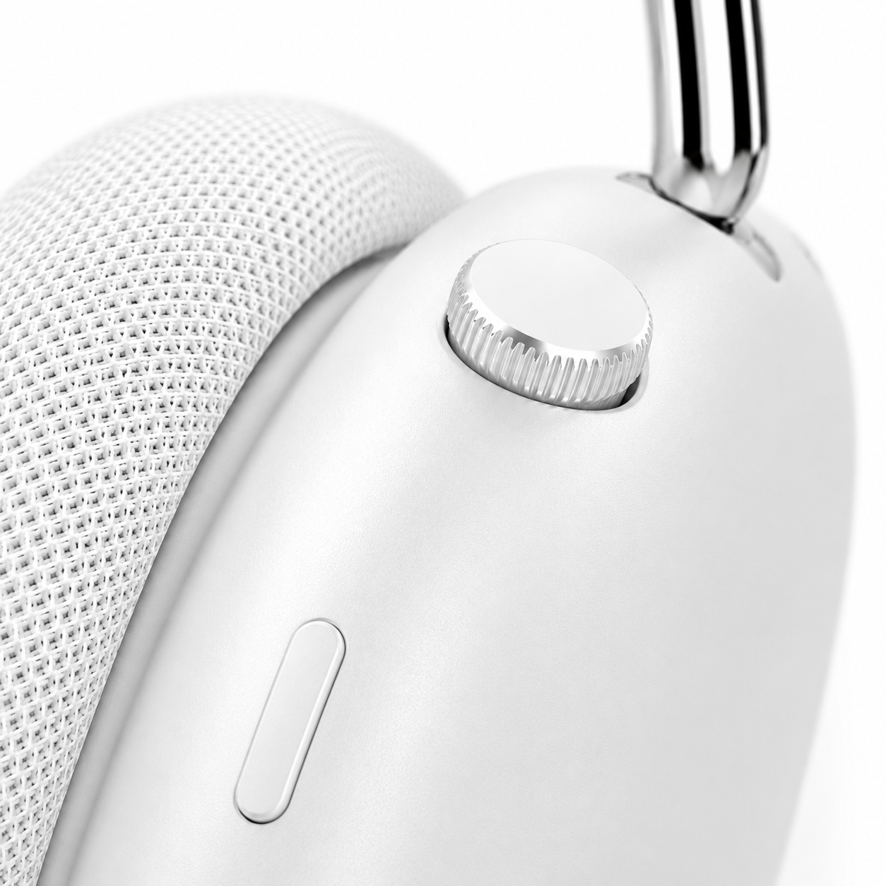 Macro product photography highlighting the precision-machined control dial and multifunction button on premium white wireless headphones, showcasing the minimalist design, textured ear cushions, and premium aluminum support arm.