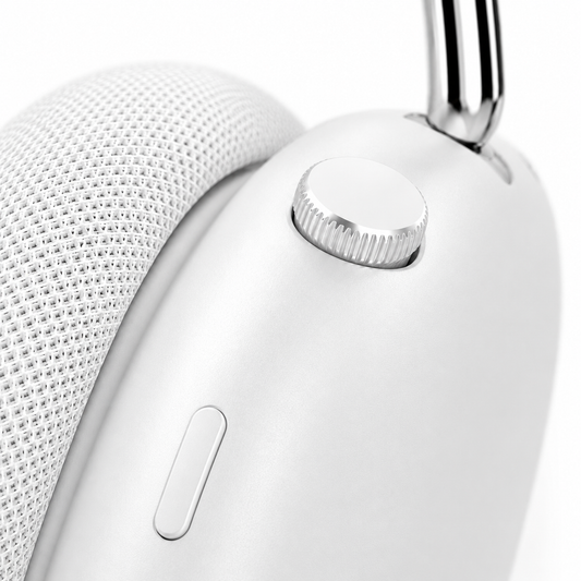 Macro product photography highlighting the precision-machined control dial and multifunction button on premium white wireless headphones, showcasing the minimalist design, textured ear cushions, and premium aluminum support arm.