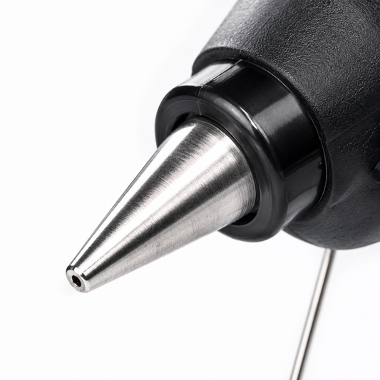 Macro shot of the precision metal nozzle on a 100W hot melt glue gun, ideal for accurate adhesive application in crafts, DIY and home repairs.