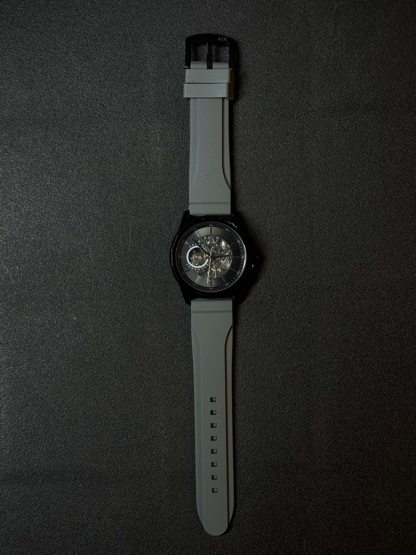 Replica watch featuring grey silicone strap, open-heart skeleton dial, luxury sports design and black case for men