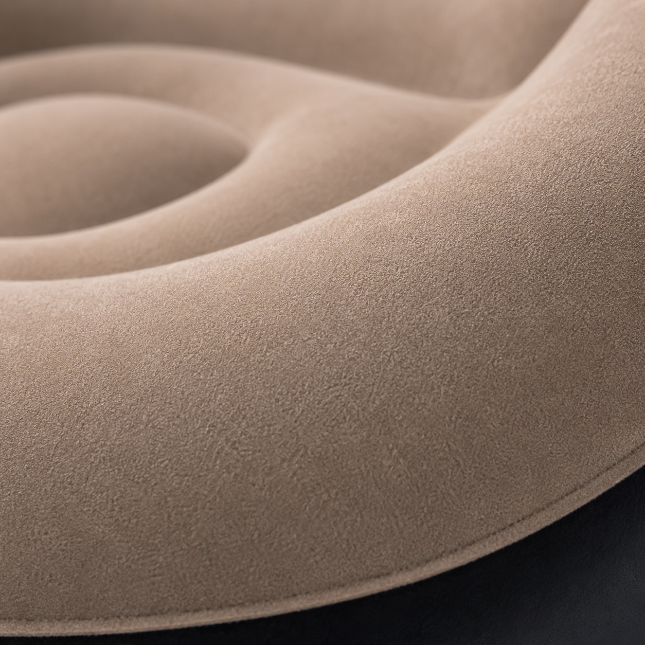 Extreme close-up of the soft flocked fabric surface on an inflatable sofa chair, showcasing the plush texture, smooth contours, and premium comfort-focused upholstery details.