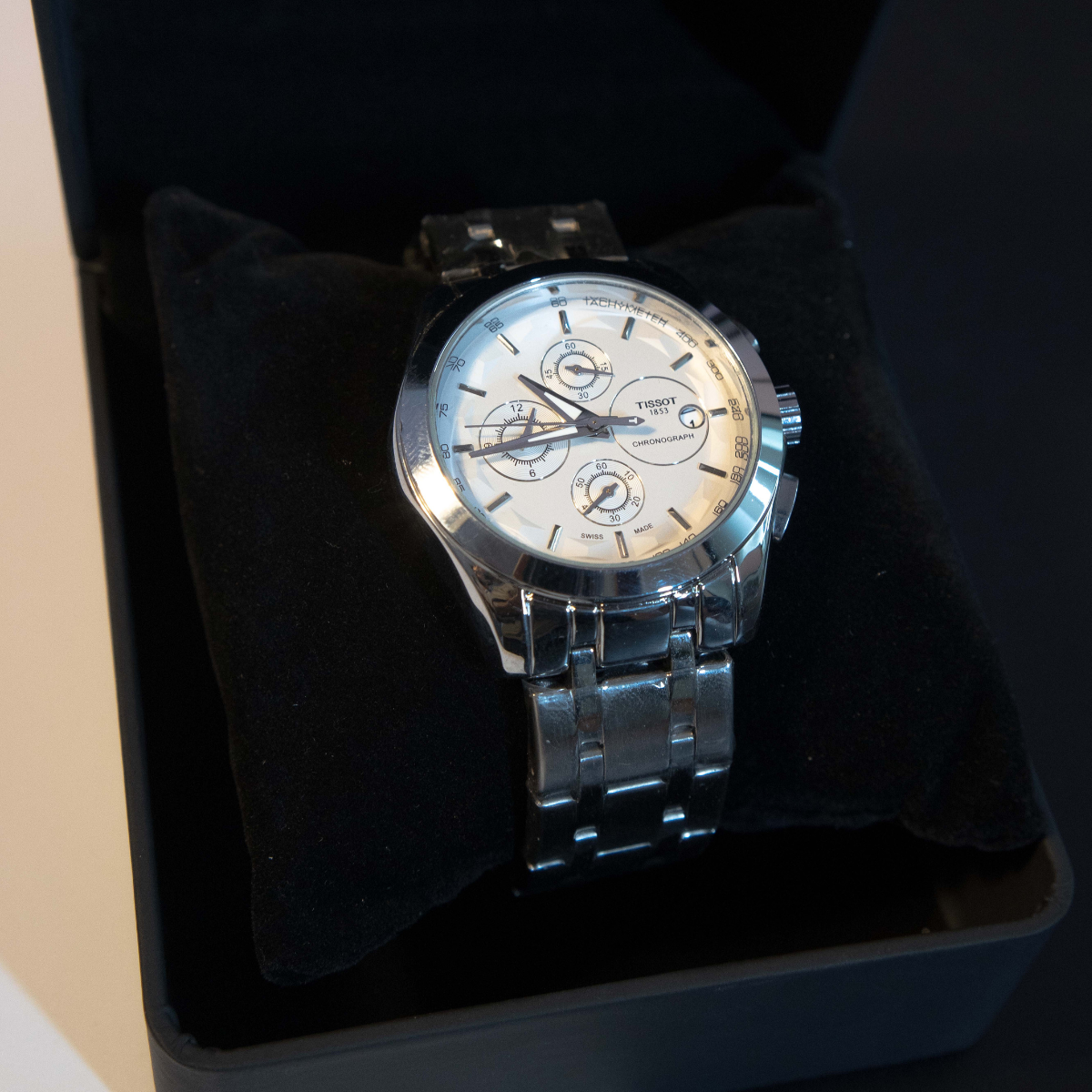 Silver Chronograph Men’s Watch with stainless steel bracelet and white dial displayed in premium watch box