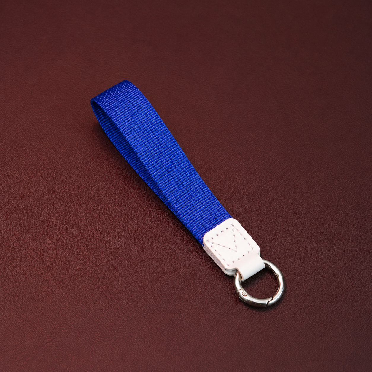 Detachable wrist strap with metal ring attachment for convenient carrying of sports water bottles during travel and outdoor activities.
