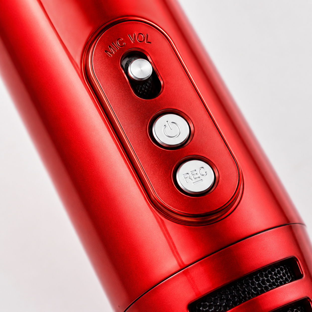 Macro view of the wireless karaoke microphone control panel featuring microphone volume slider, power button, and recording button on a sleek metallic red body.