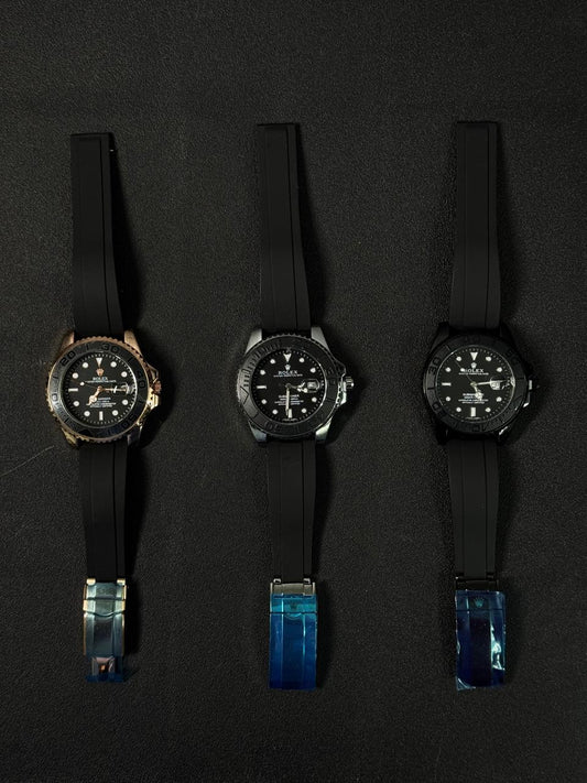 Luxury replica watch collection featuring automatic dive watches with black rubber Oysterflex-style straps on a dark background.