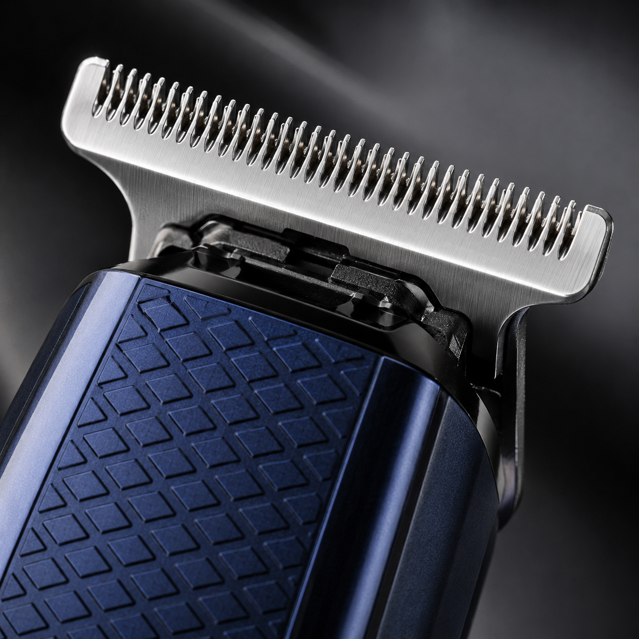 Macro close-up of stainless steel T-precision blade on a professional cordless hair trimmer, showcasing sharp cutting teeth and premium metal construction.