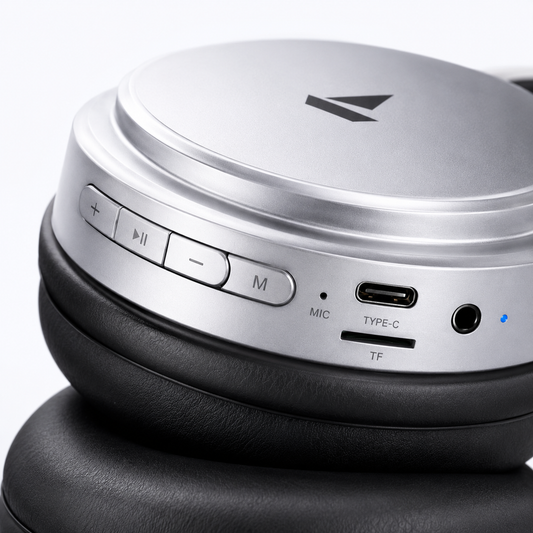 Premium silver over-ear wireless Bluetooth headphones with soft memory foam ear cushions, adjustable headband, built-in microphone, Type-C charging port, TF card slot, AUX input, and multifunction control buttons for immersive Hi-Fi stereo audio.