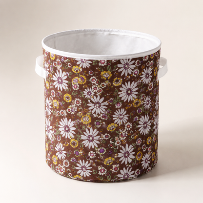 Round brown floral fabric laundry basket with handles for storing clothes, laundry, toys and household essentials.