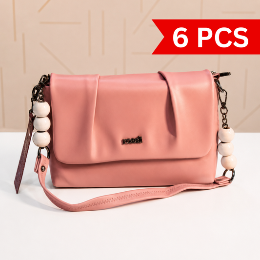 Front view of a blush pink women's shoulder and crossbody bag with a pleated flap, decorative white beaded chain handles, structured silhouette, and adjustable detachable strap.