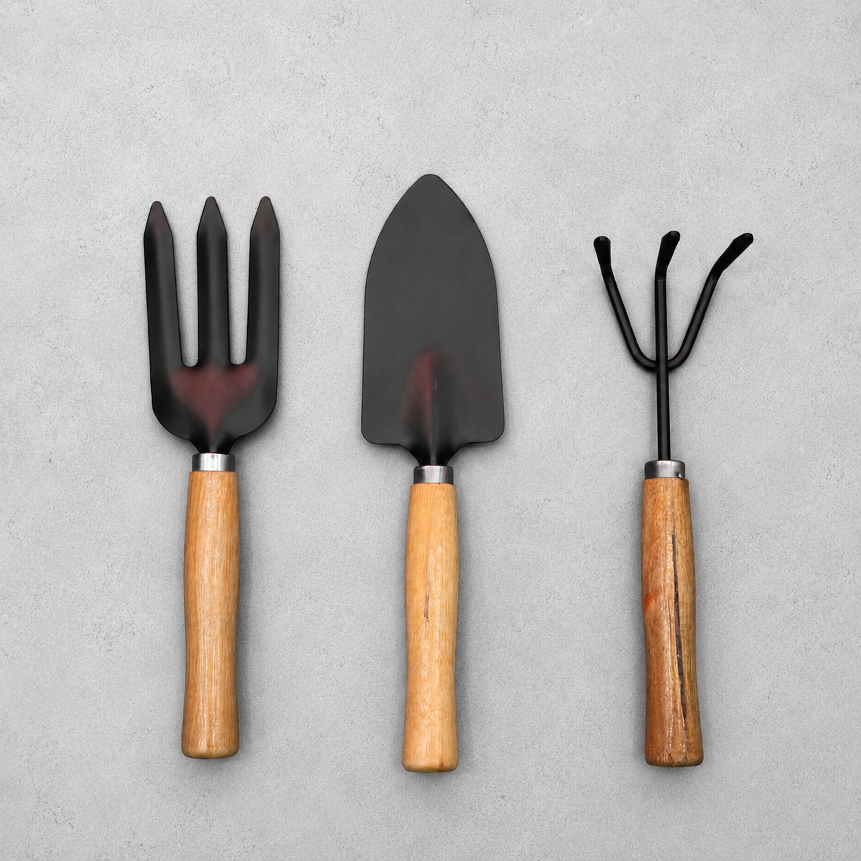 3-in-1 Home Gardening Tools Set with hand trowel, cultivator fork and garden rake featuring durable black metal heads and wooden handles