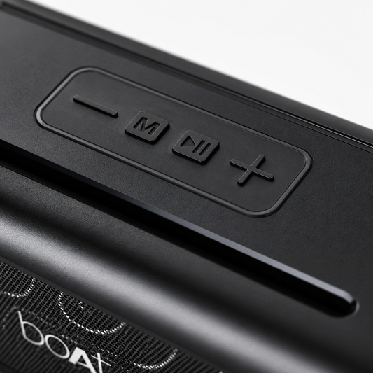 Premium close-up of the textured top panel featuring tactile volume, mode, play/pause, and volume control buttons on a rugged portable wireless Bluetooth speaker.