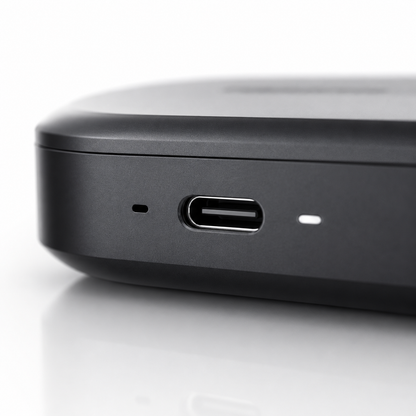 Close-up of the USB Type-C charging port on a premium wireless earbuds charging case with matte black finish and LED status indicator, designed for fast and convenient charging.