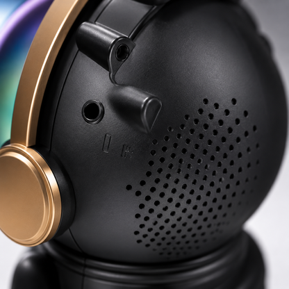 Rear close-up of the astronaut Bluetooth speaker showing the speaker grille, AUX port and durable matte black finish with premium gold accents.