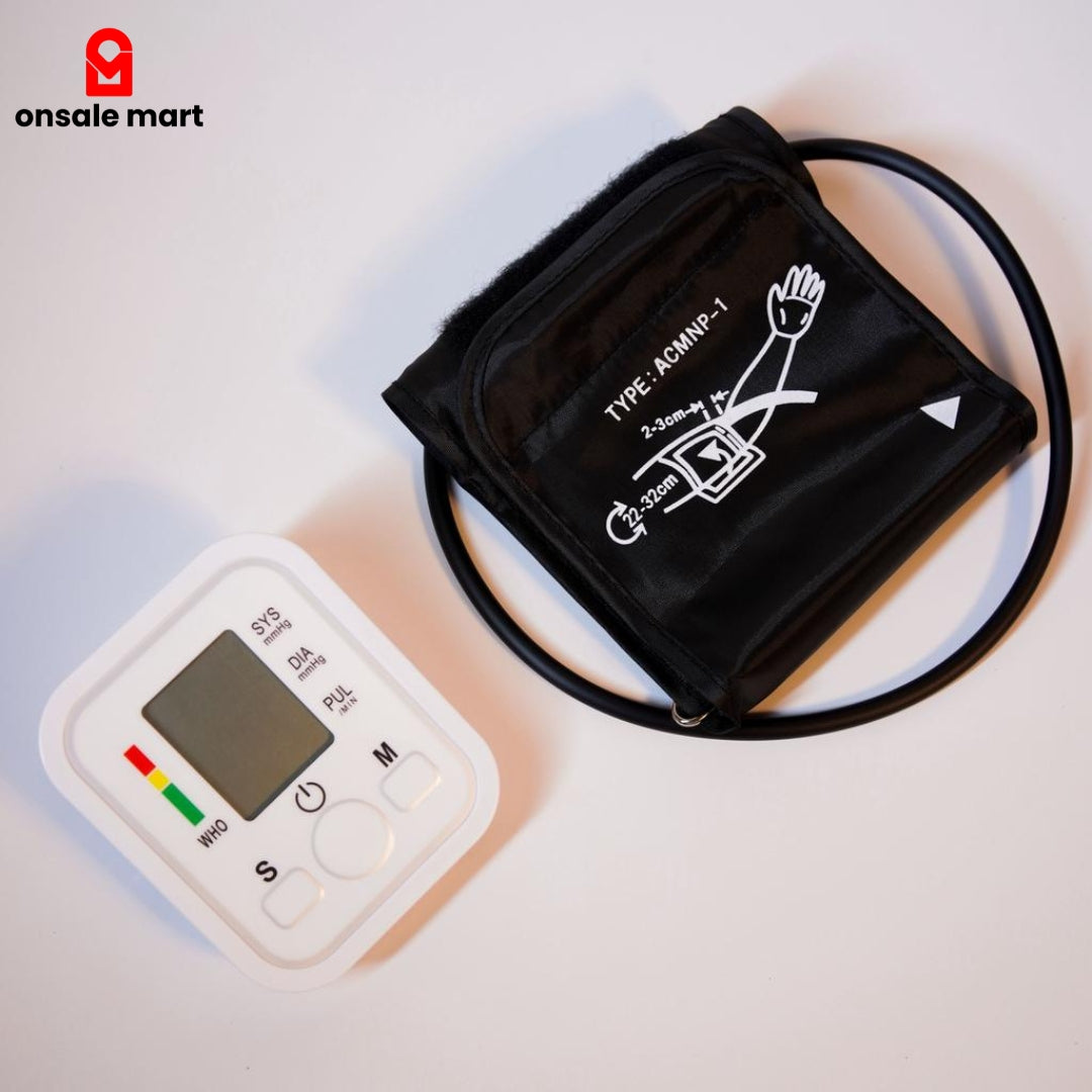 Automatic blood pressure monitor with upper arm cuff placed on a white surface.