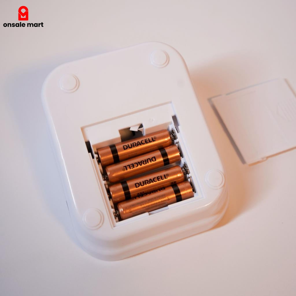 Battery compartment of the home blood pressure machine showing AAA batteries inserted.