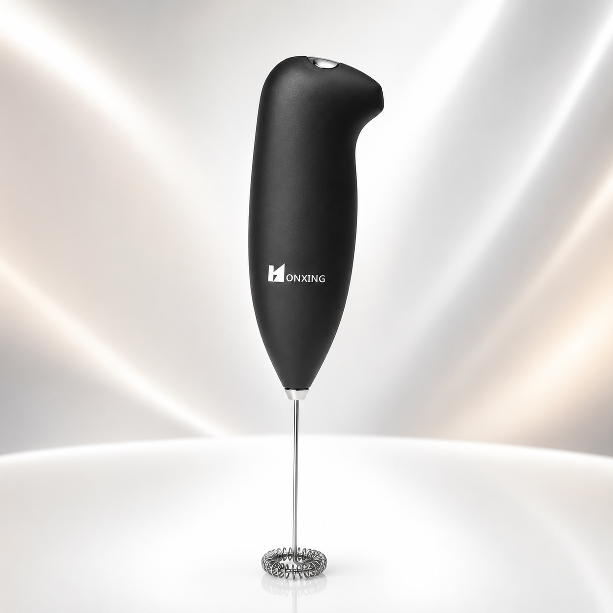 Premium handheld battery-operated milk frother featuring a soft-touch black ergonomic handle and stainless steel whisk, ideal for frothing milk for cappuccino, latte, hot chocolate, and coffee beverages.