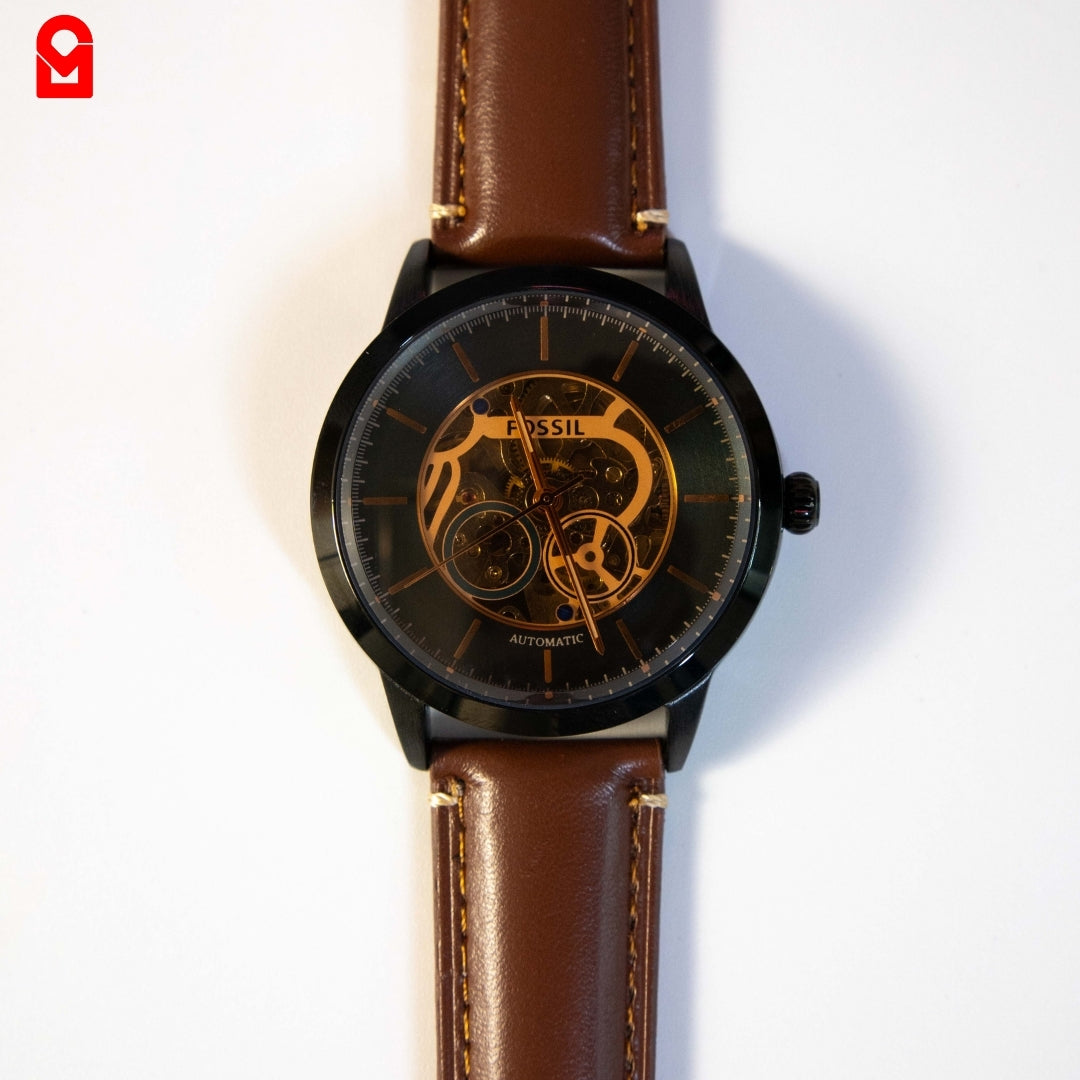 Close-up of black automatic skeleton dial showing mechanical movement details.