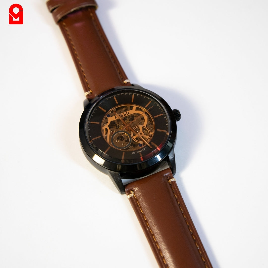 Men’s automatic skeleton watch with black case and brown leather band full view.