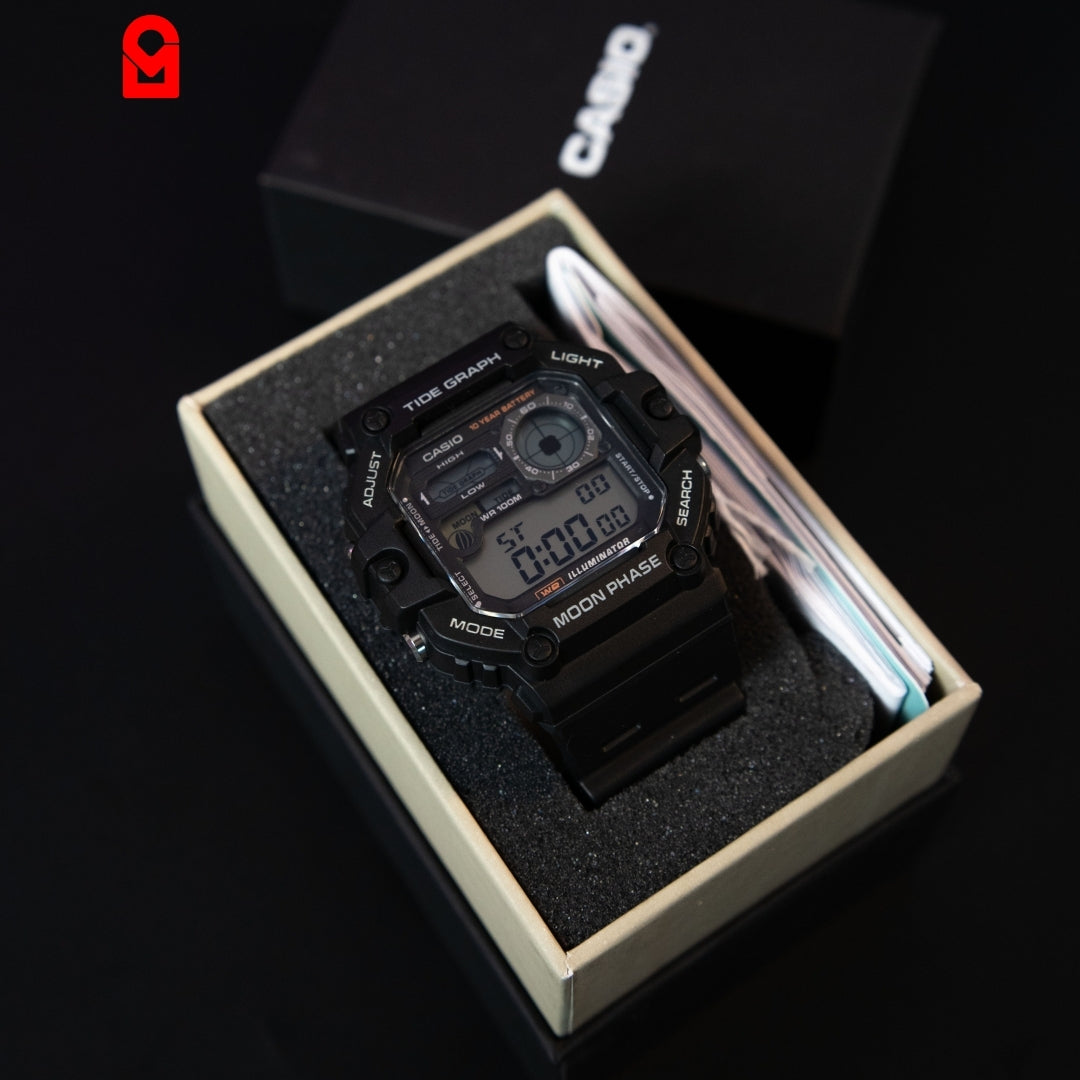 Digital sports watch with rugged square case, resin strap and multifunction display shown in box packaging.