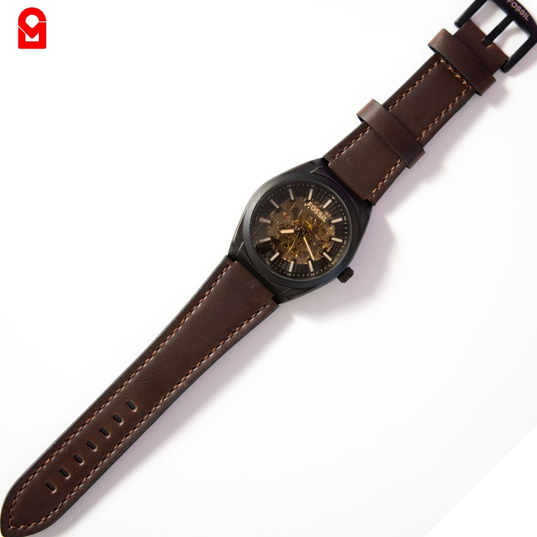 Men’s automatic skeleton watch showing open mechanical dial and leather strap.