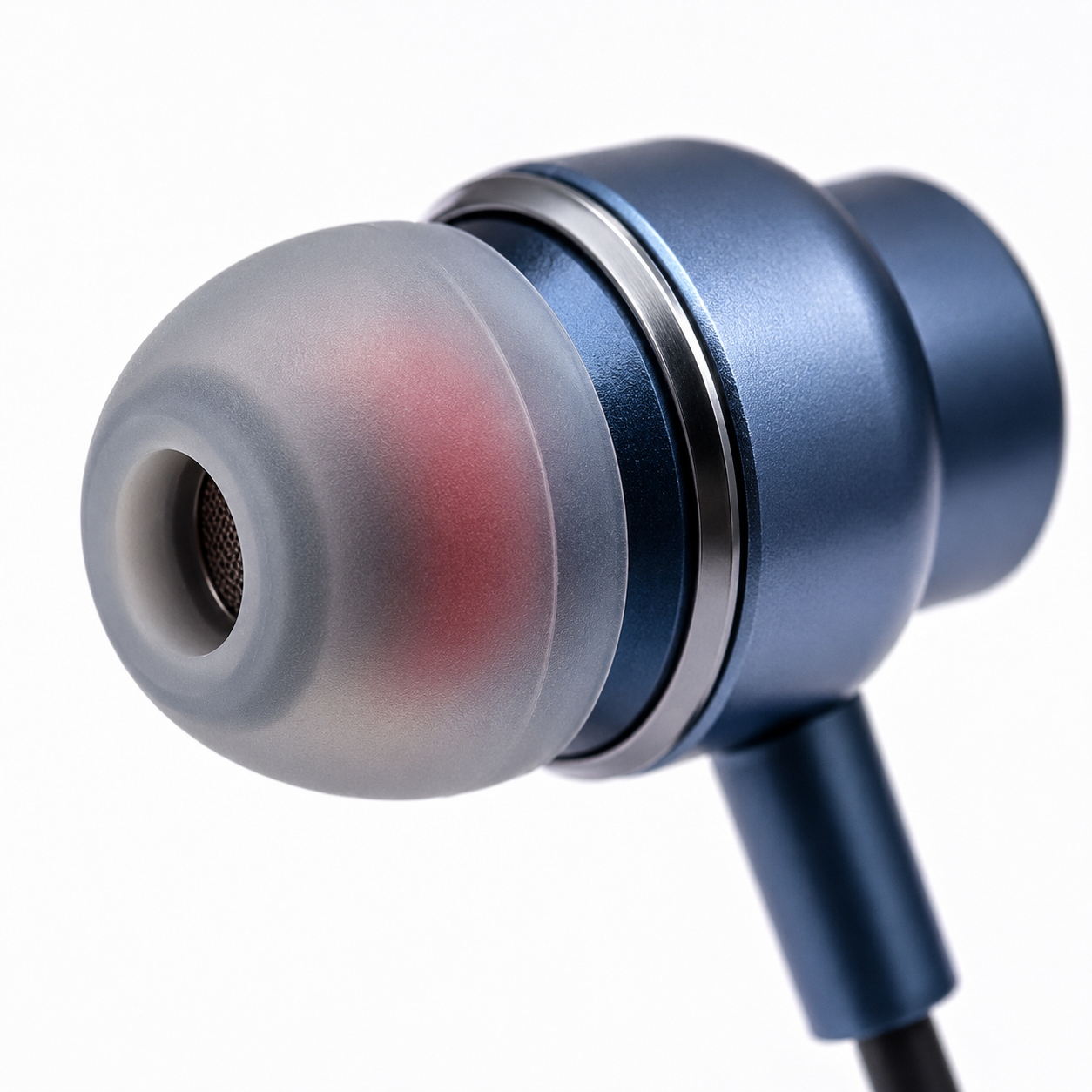 Close-up macro of the metallic blue in-ear earbud with soft silicone ear tip, showcasing premium finish and ergonomic design.