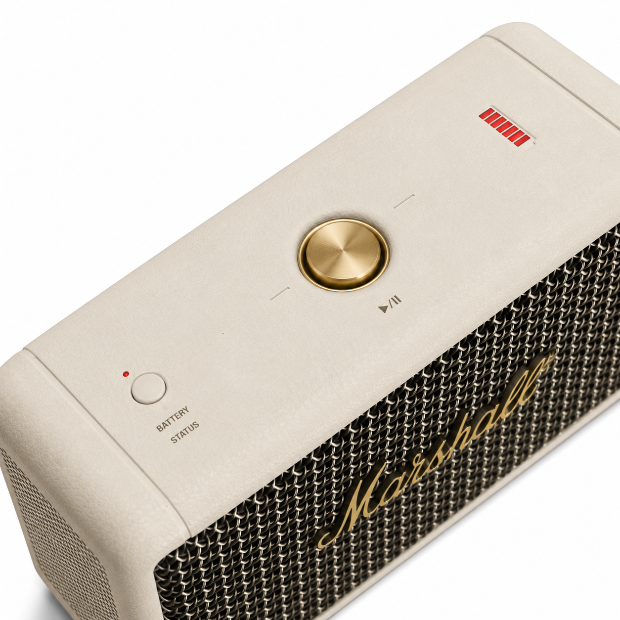 Close-up of the portable Bluetooth speaker showcasing the premium gold multifunction control knob, battery status indicator and textured cream finish for easy operation.
