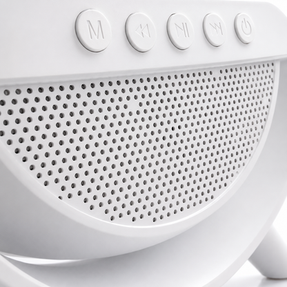 Macro close-up of the front speaker grille and multifunction control buttons on the LED wireless charging Bluetooth speaker with modern white minimalist design.