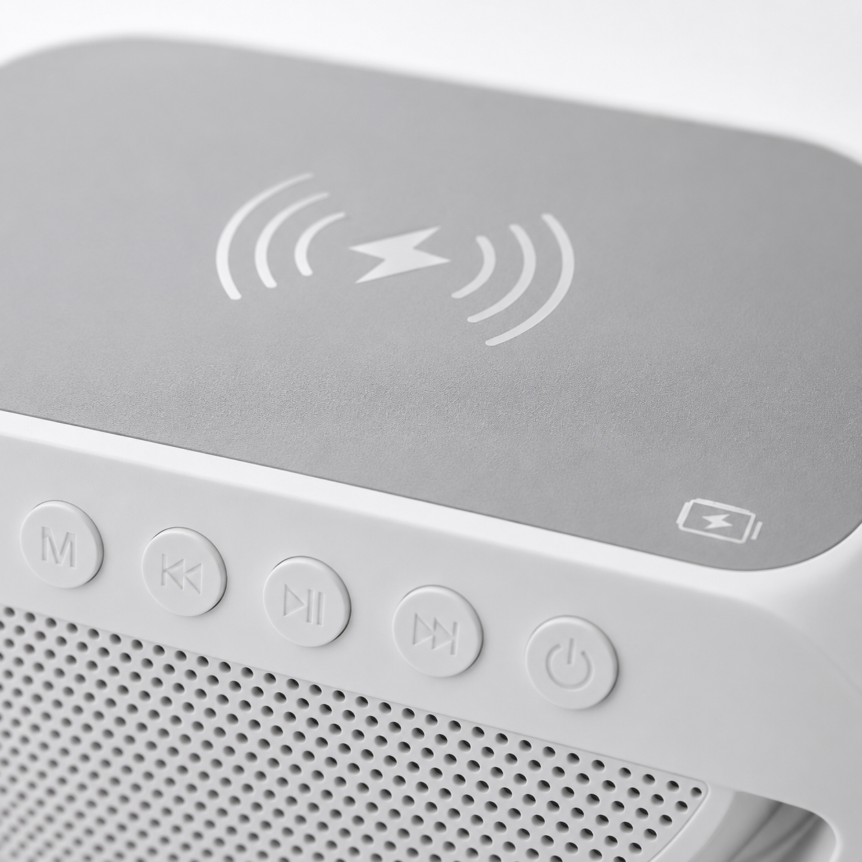 Close-up of the LED wireless charging Bluetooth speaker showing the soft-touch wireless charging pad with Qi charging symbol, integrated control buttons, and premium white finish.