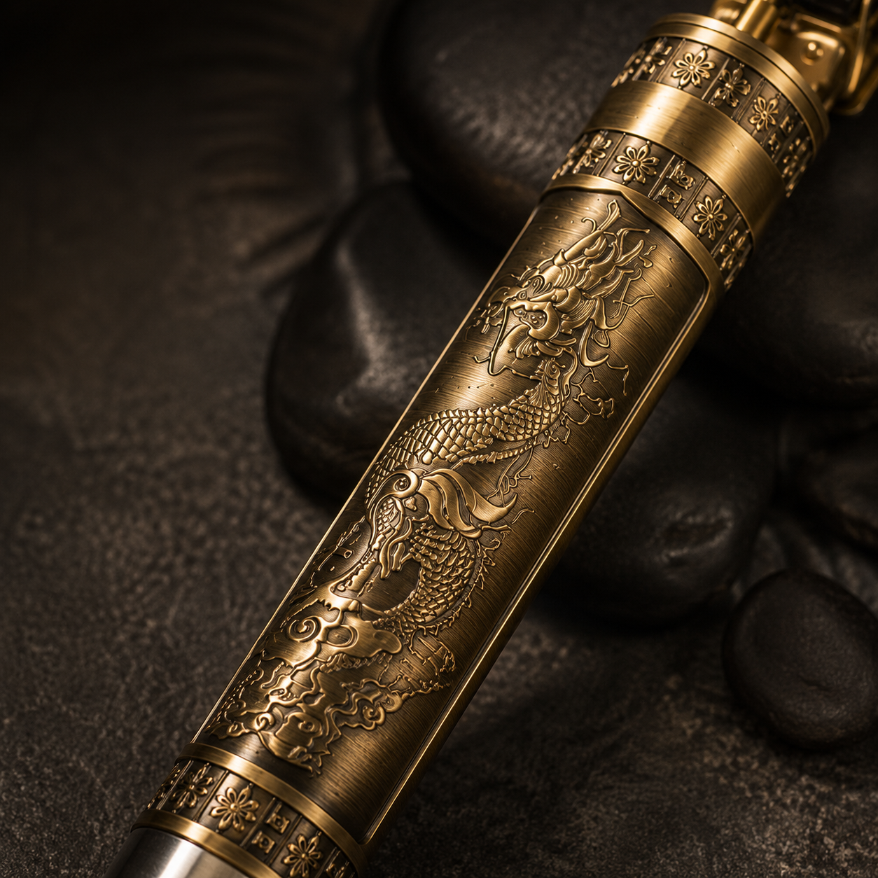 Close-up of premium dragon engraved metal hair trimmer body with antique gold finish, showcasing detailed craftsmanship and textured design.