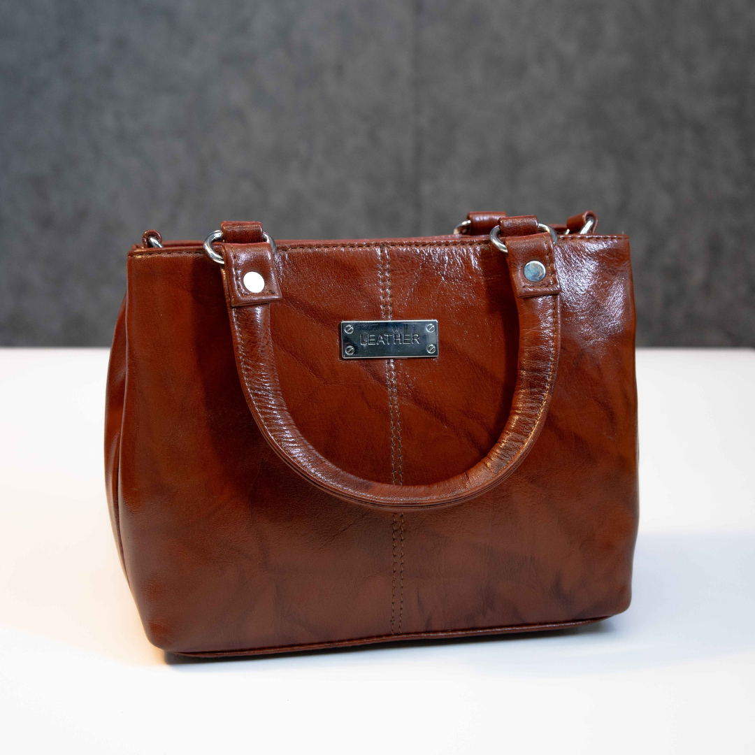 Classic brown leather tote bag with structured design and top handles.