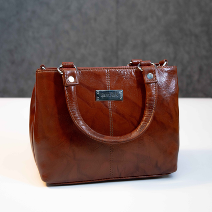 Classic brown leather tote bag with structured design and top handles.
