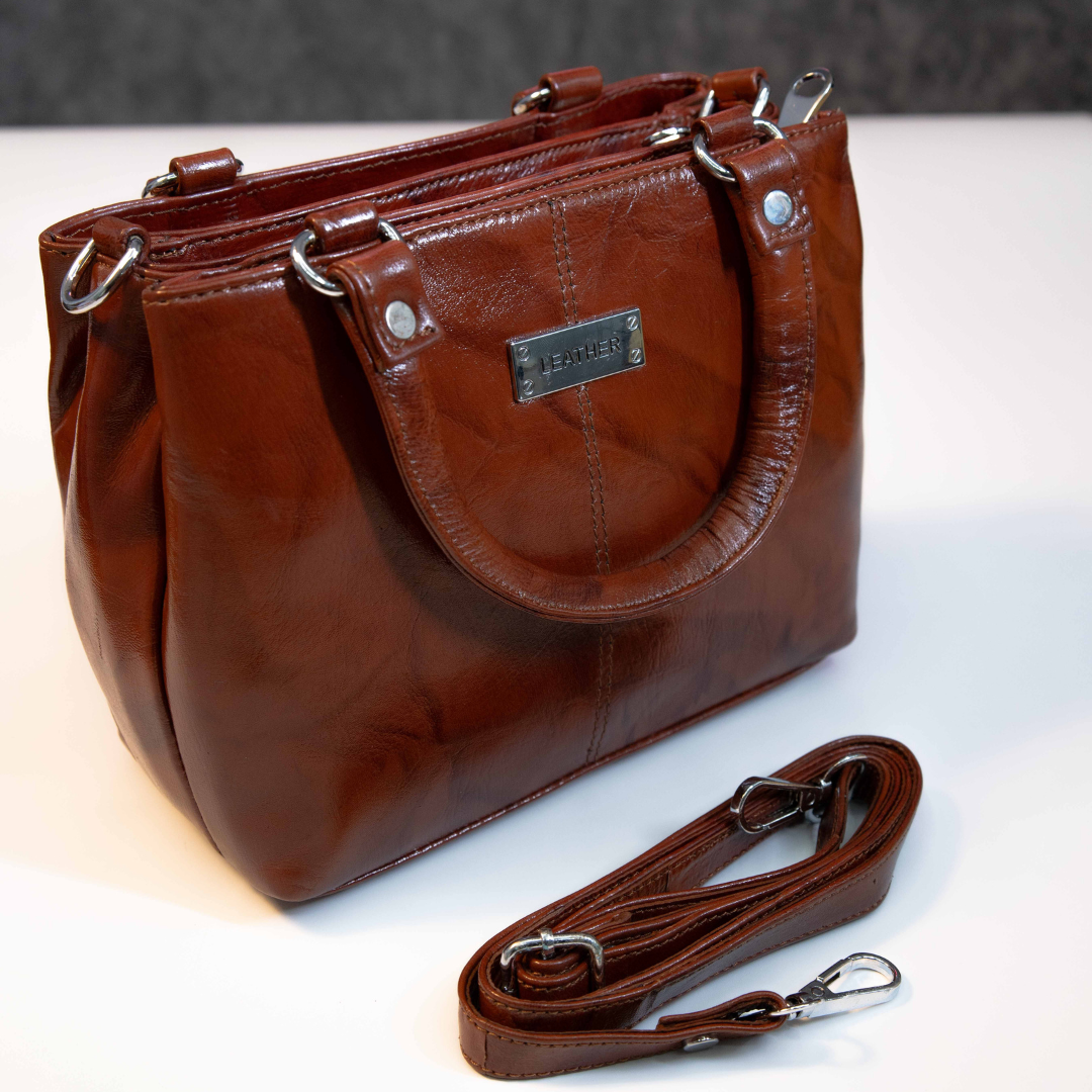 Brown leather tote bag with detachable shoulder strap and sturdy handles.