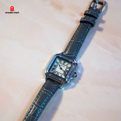 Square analog watch with white Roman numeral dial, polished silver-tone case, and grey crocodile-texture leather strap.