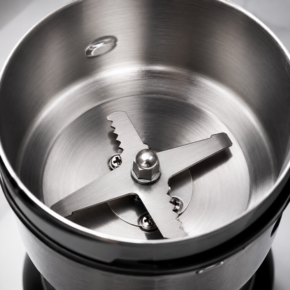 Stainless steel grinding bowl with sharp metal cross blade designed for efficient grinding of coffee beans, spices and dry ingredients.