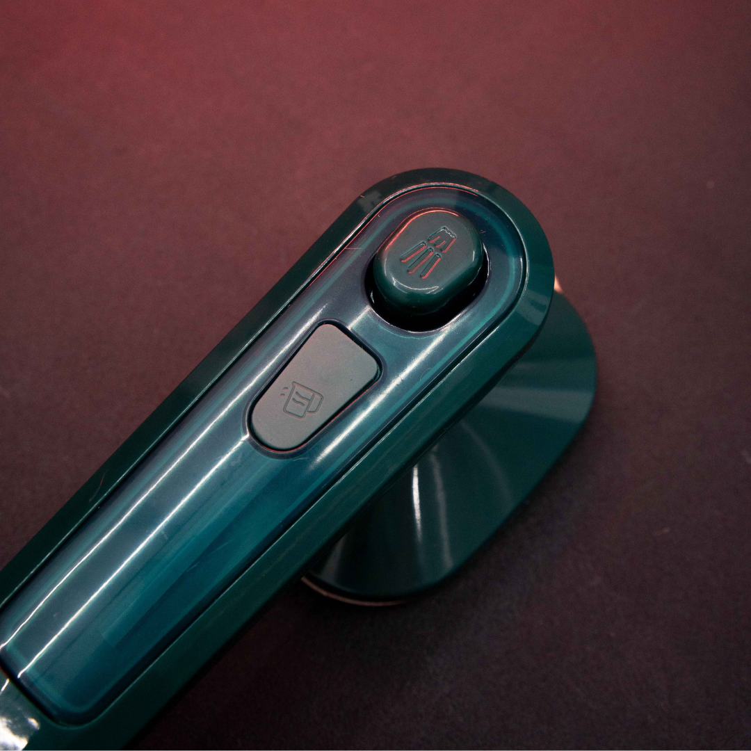 Top view of Compact Dry Iron with Mist Spray featuring ergonomic handheld controls and compact lightweight body
