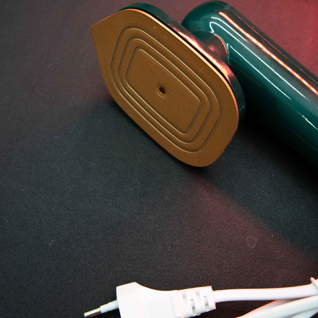Compact Dry Iron with Mist Spray close-up showing smooth non-stick soleplate and portable travel-friendly design