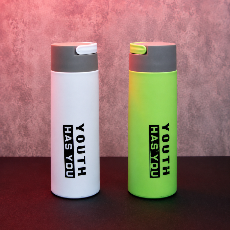 Two reusable insulated water bottles in white and green with flip-top lids, modern minimalist design for office, school and travel use.