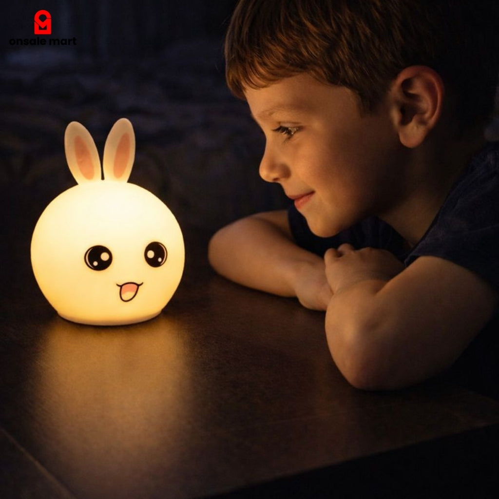 Child looking at Cute Bunny Night Light glowing warmly on table at night in a cozy bedroom.