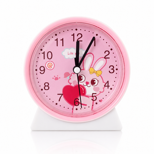 Pink rabbit alarm clock for kids featuring cute bunny artwork, large analog numbers, battery-powered operation, and bedside table design.