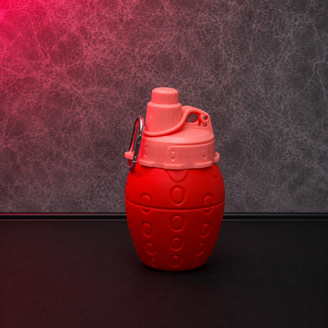 Red strawberry shaped reusable kids water bottle with easy-sip spout, compact portable design and secure carry clip for daily hydration