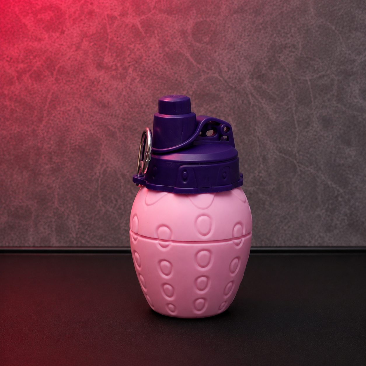 Pink strawberry shape kids water bottle with leak-resistant flip-top lid, portable carry ring and textured fruit design for school and travel