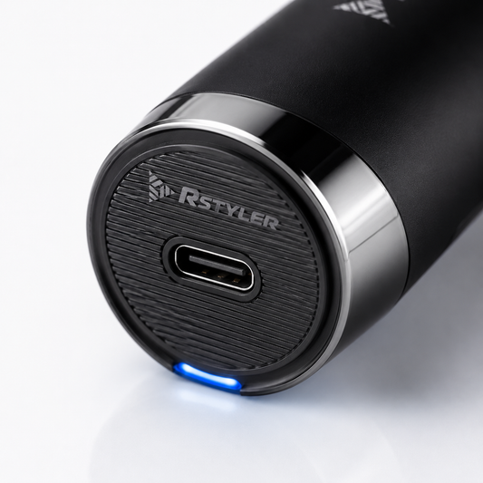 Close-up macro image of a professional hair trimmer with USB Type-C charging port, textured base, LED charging light, and premium cordless grooming design.