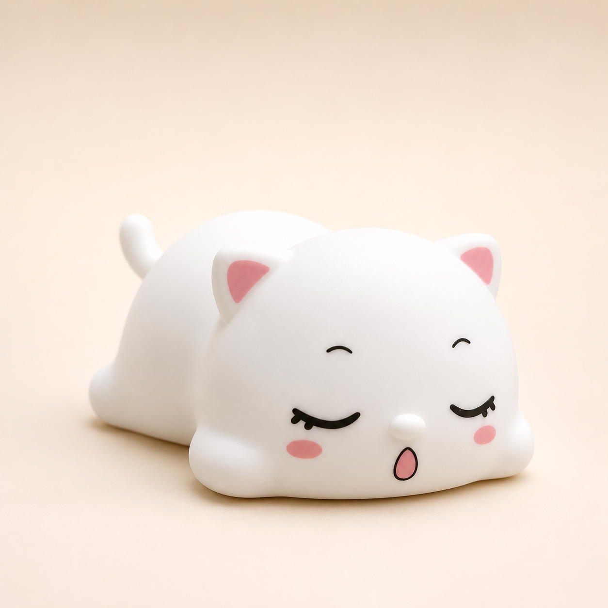 Cute sleeping cat silicone night lamp with soft white body, pink ears and peaceful sleeping expression, ideal for bedside décor and kids room lighting.