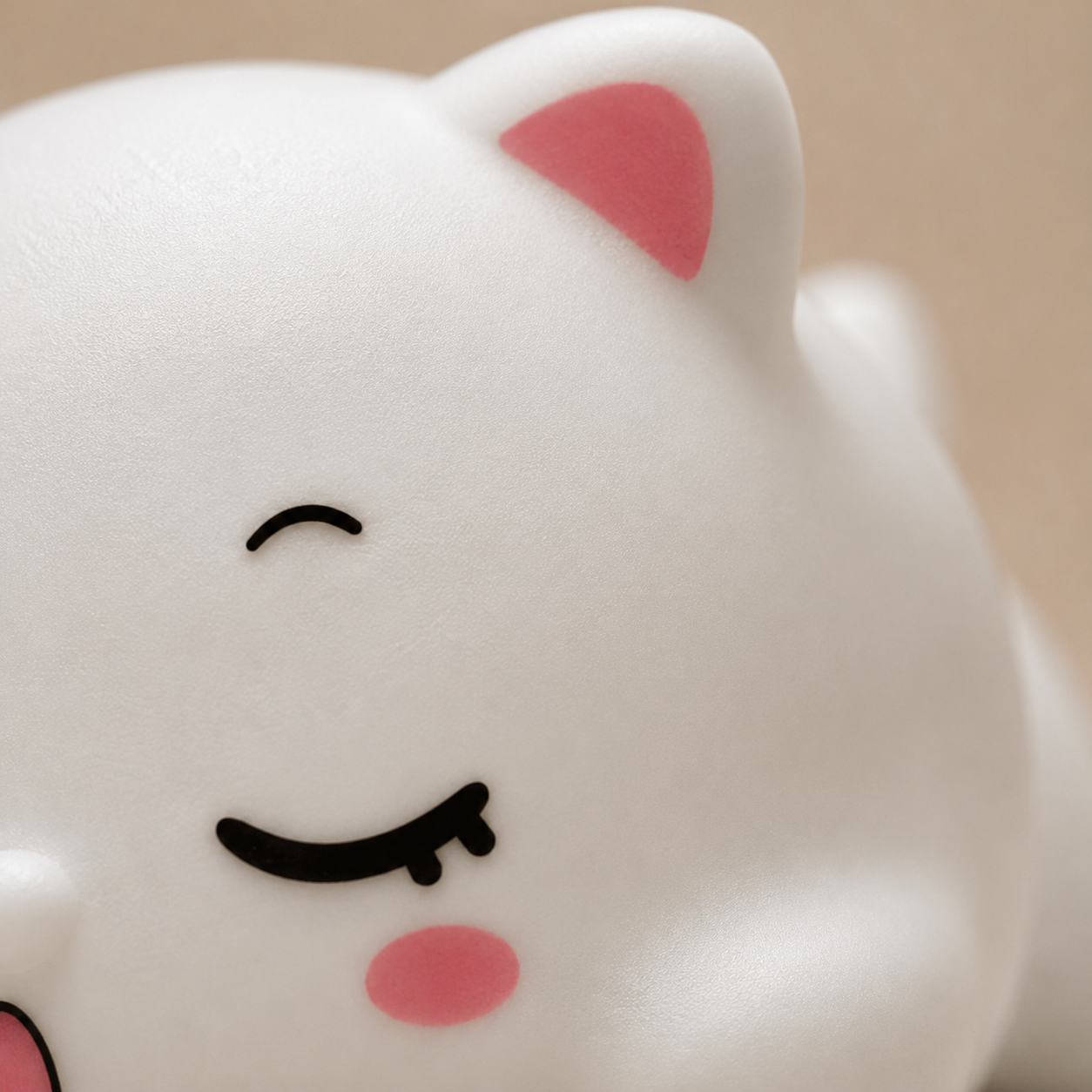 Extreme close-up of sleeping cat silicone night light, showcasing soft-touch texture, pink ear detail, closed eyes and cute bedtime design.