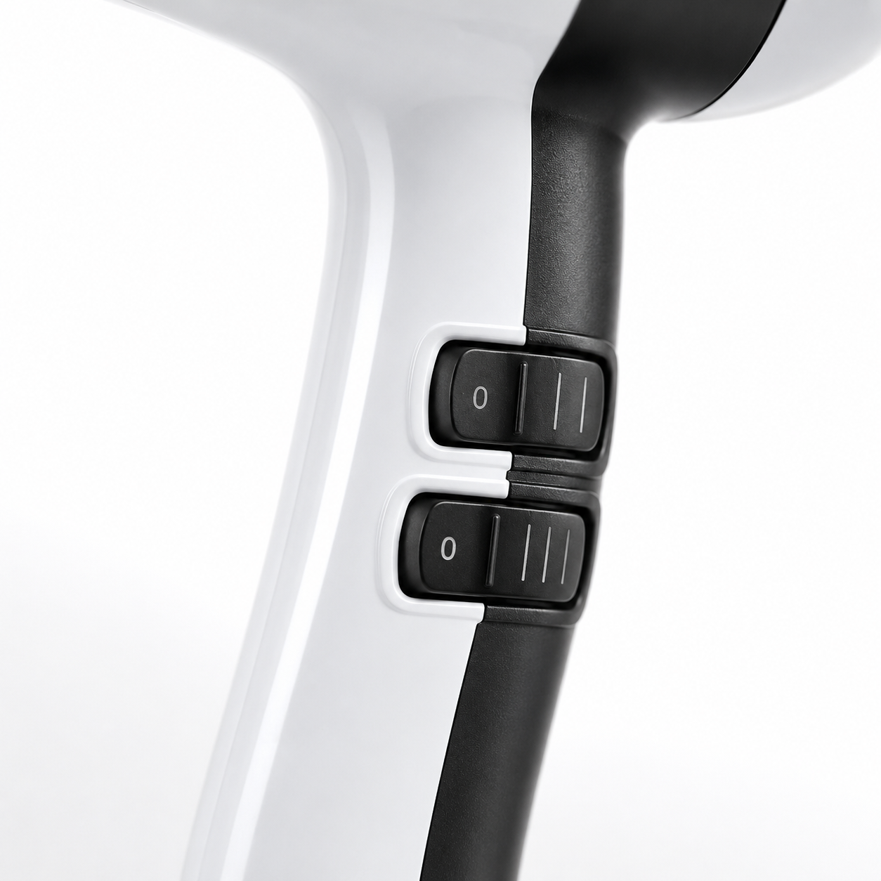 Close-up of the hair dryer's dual control switches showing adjustable heat and speed settings on an ergonomic handle for customized styling and drying.