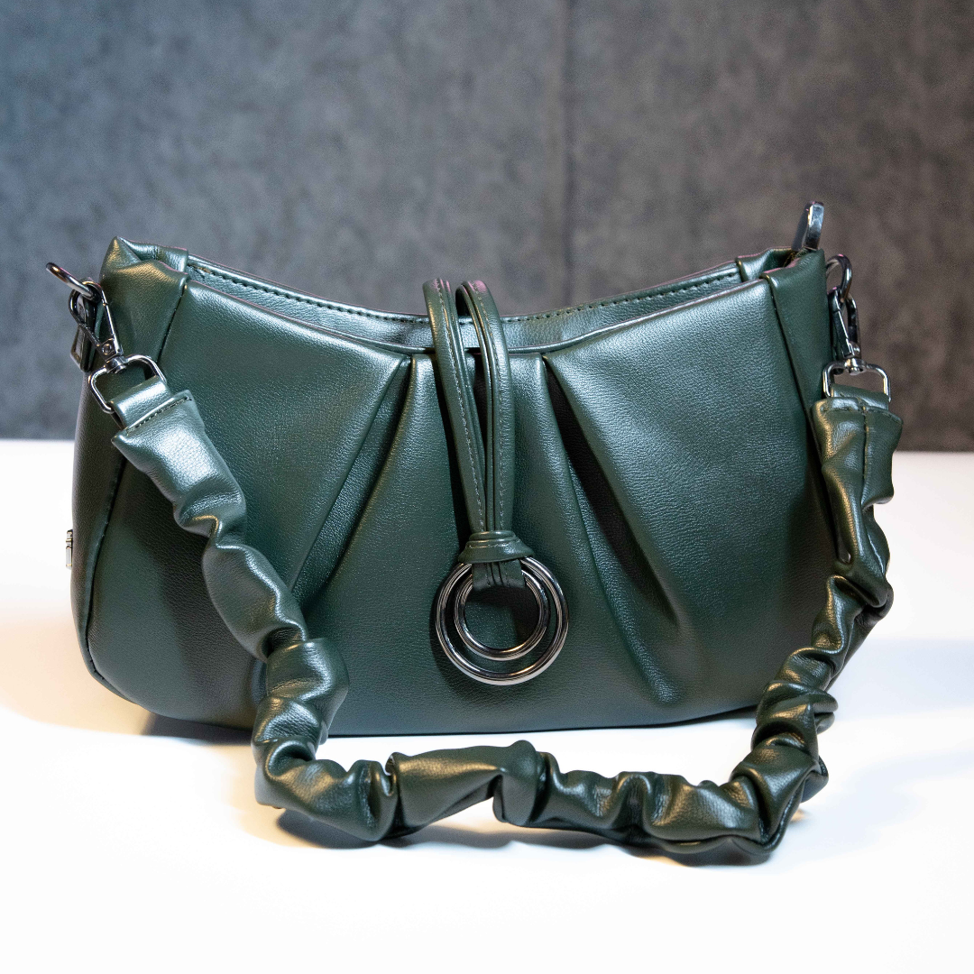 Emerald green ruched bag featuring metal ring detail and soft handle.