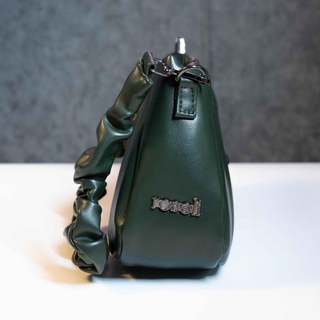 Emerald green ruched shoulder bag with compact side profile.