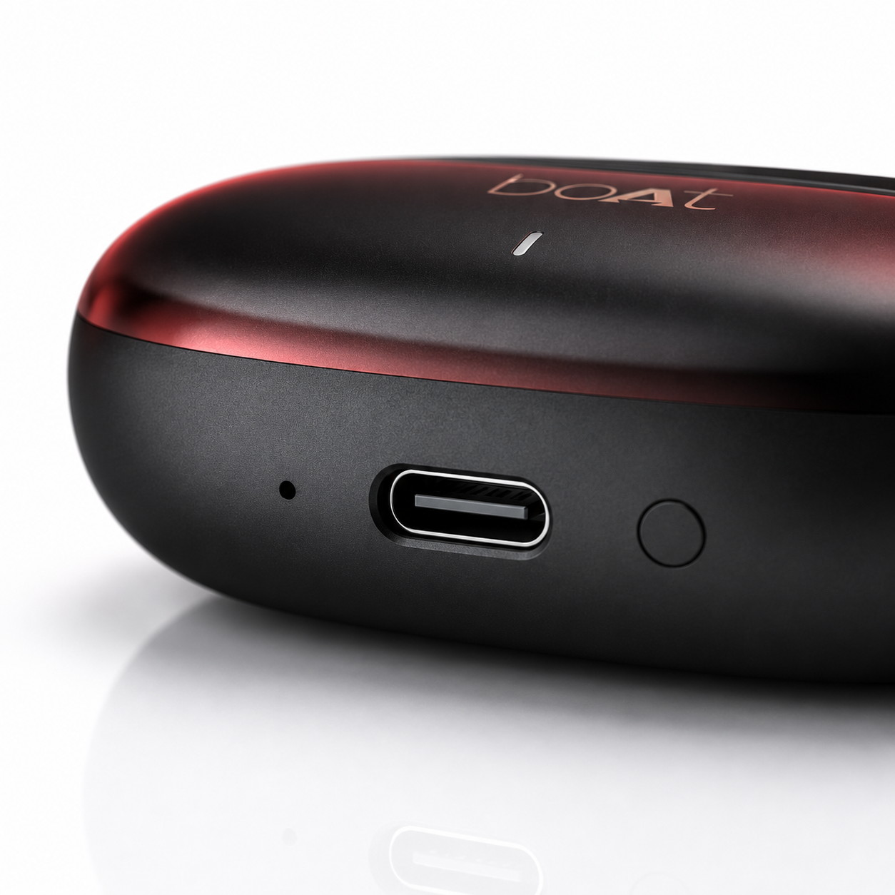Close-up of the USB Type-C charging port on a premium matte black and metallic red wireless earbuds charging case, featuring a built-in LED charging indicator and a sleek compact design for fast, convenient charging.