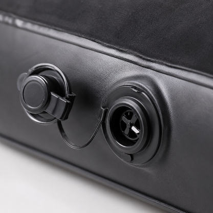 Close-up view of the air valve system on an inflatable car mattress, showing the inflation and deflation port.